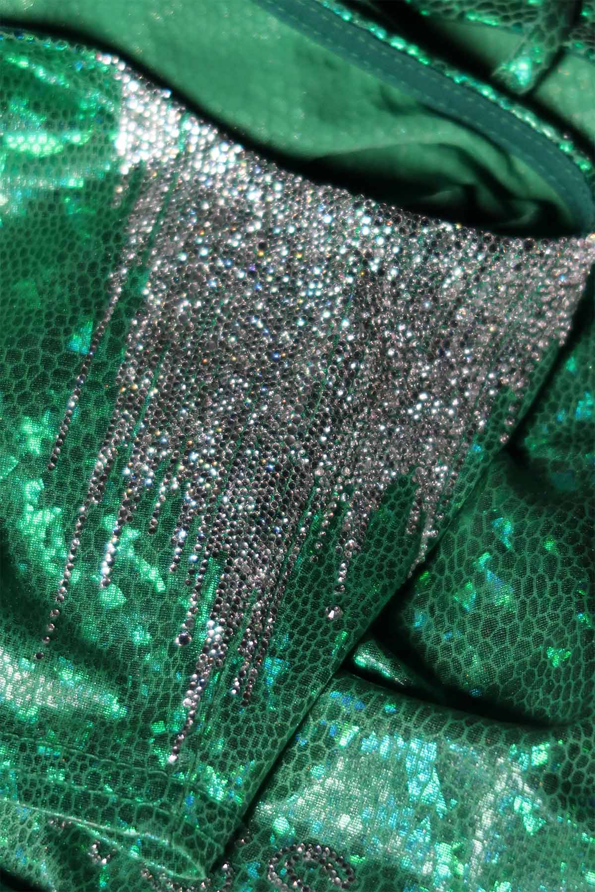 Silver rhinestones in close formations on the underarm of a top. They are in straight lines going vertically down the top.