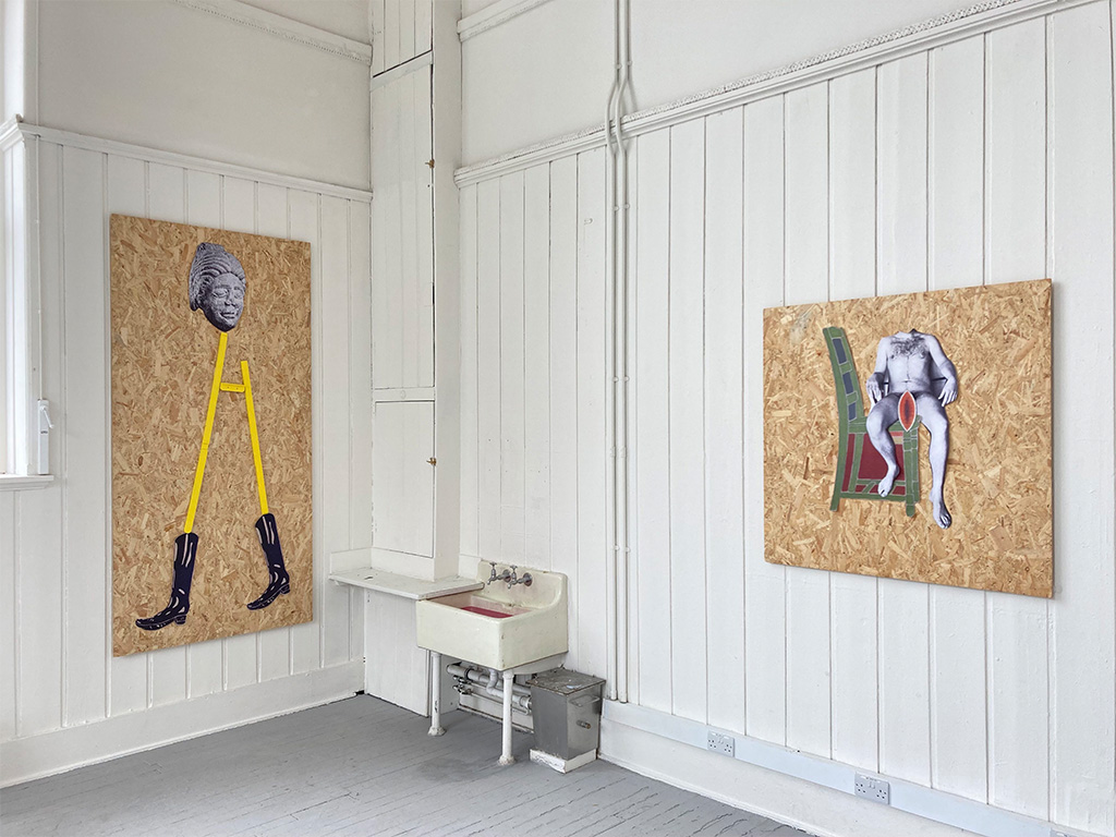 Two collages made from paper and wood hung on a wall, depicting figures. A sink full of water and pink paint.