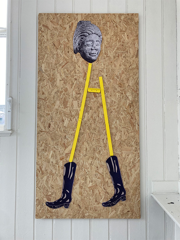 Collage depicting a figure of the roman goddess Fortuna made from paper, paint and the legs of an easel. 