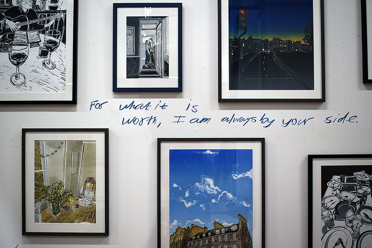 A collection of framed prints centred around handwriting which reads 'For what it is worth, I am always by your side.'