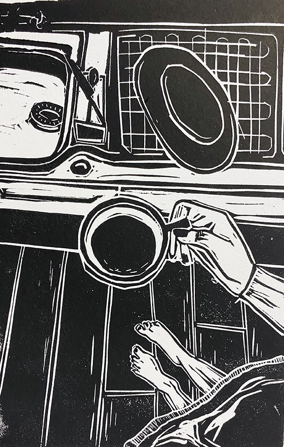 A hand holds a cup of coffee