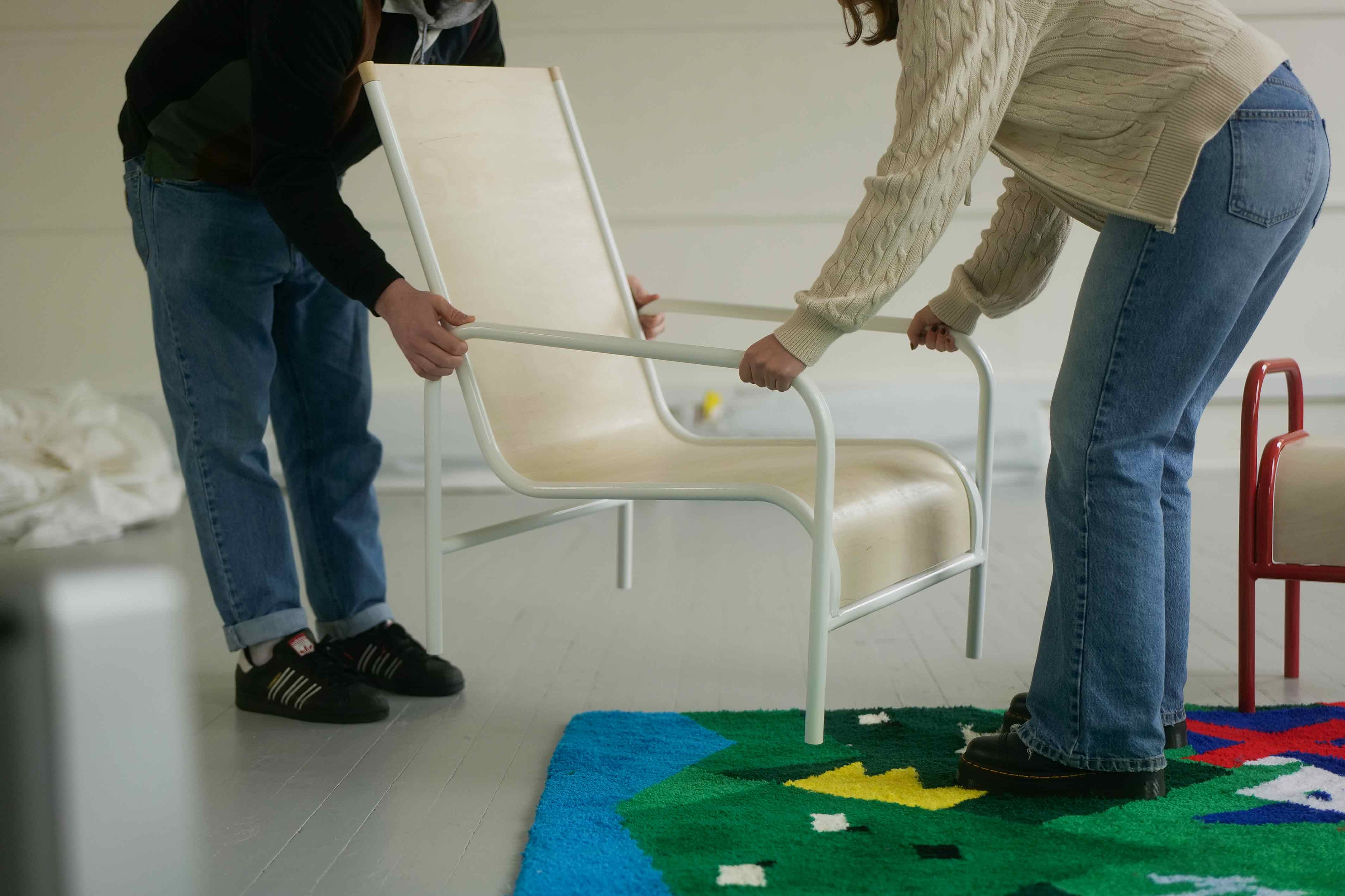 Users moving the furniture around the British Identity Rug