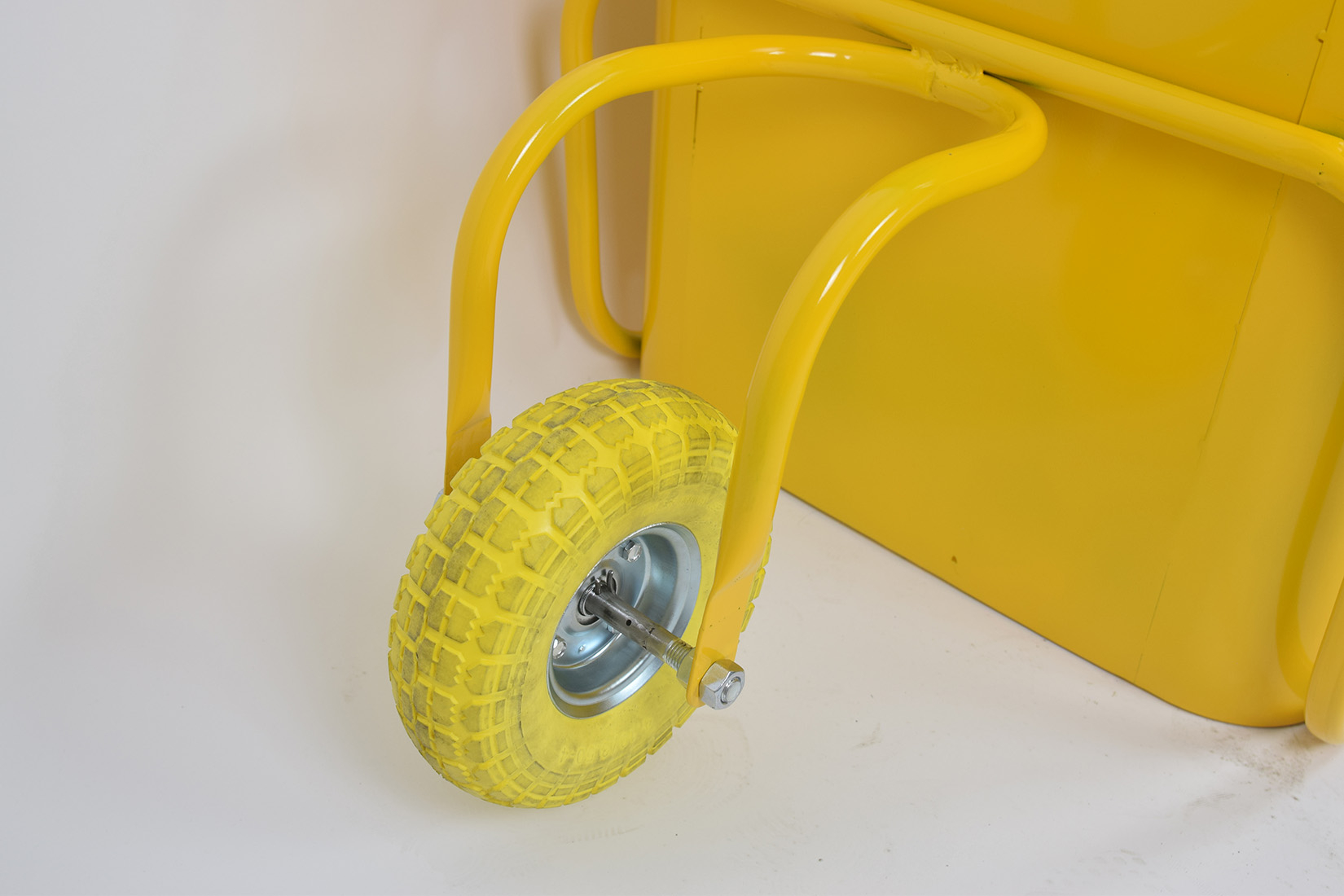 Yellow wheel on a planter.