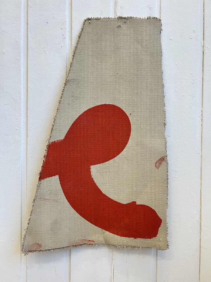 RED PAINT ON OFF-CUT CARPET.