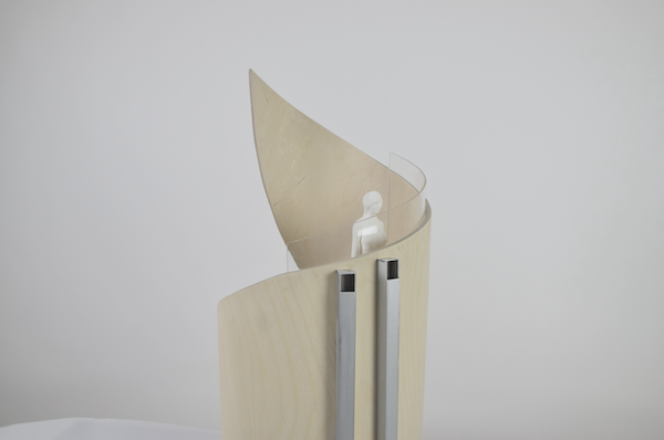 Top half of the wooden spiral, showing a scale figurine looking out