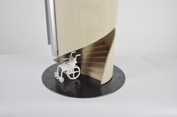 Bottom half of the wooden spiral, showing a scale model wheelchair 