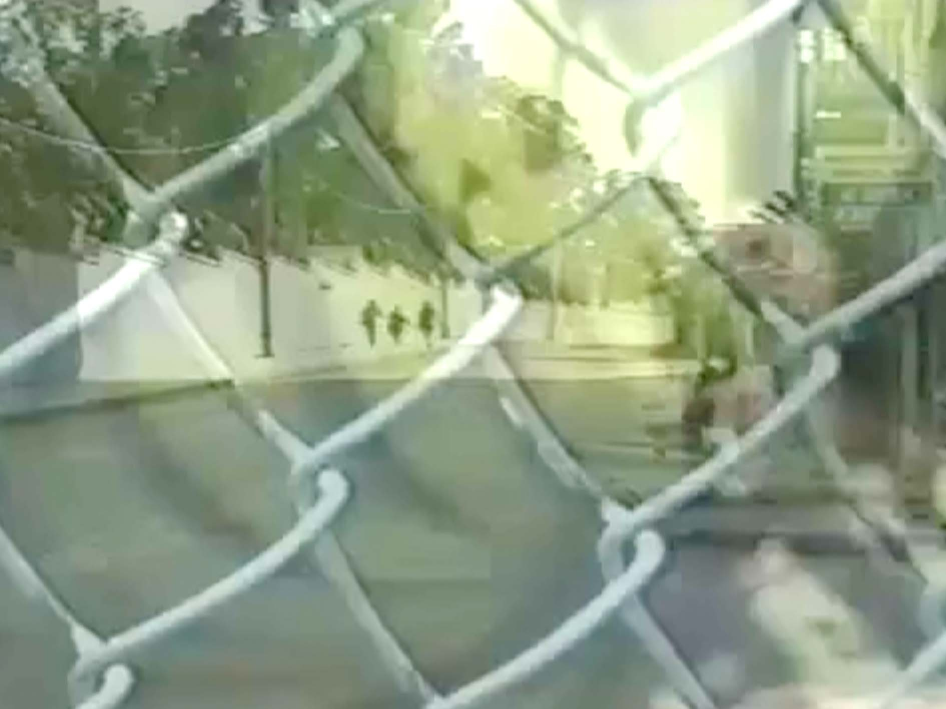 chain link fence overlooking a street 