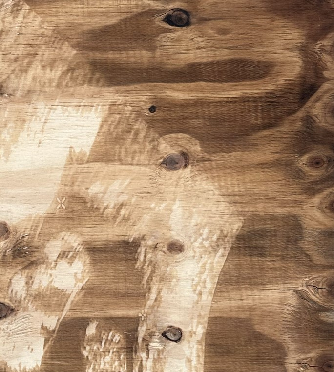 A closeup of laser-engraved plywood 