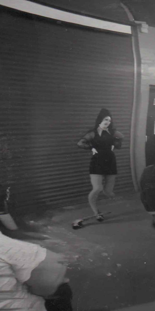Distorted image of a performer in black and white.