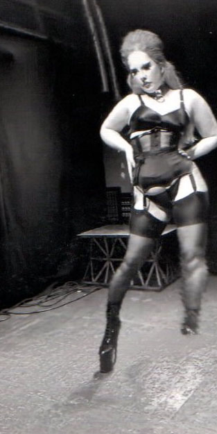 Distorted image of a performer in black and white.