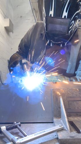 Katherine is welding the periscope together