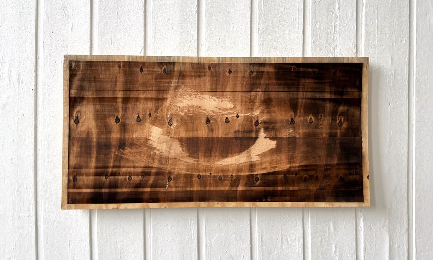 Laser-etched sonogram on a sheet of plywood 