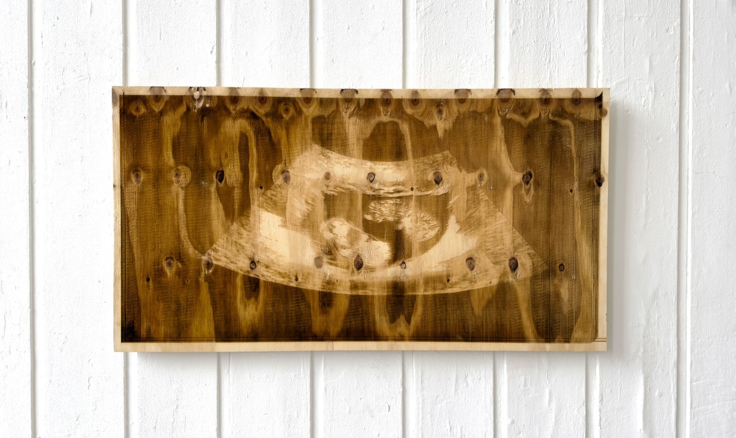 Laser-etched sonogram on a sheet of plywood 