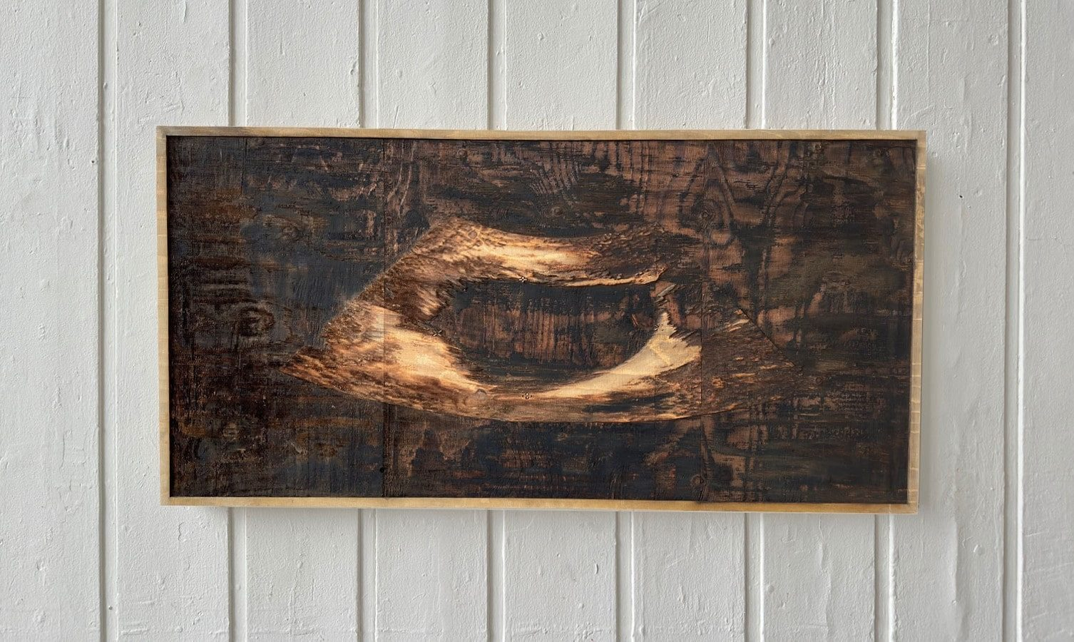 Laser-etched sonogram on a sheet of plywood 