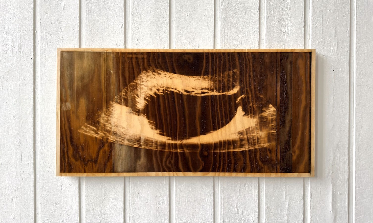 Laser-etched sonogram on a sheet of plywood 
