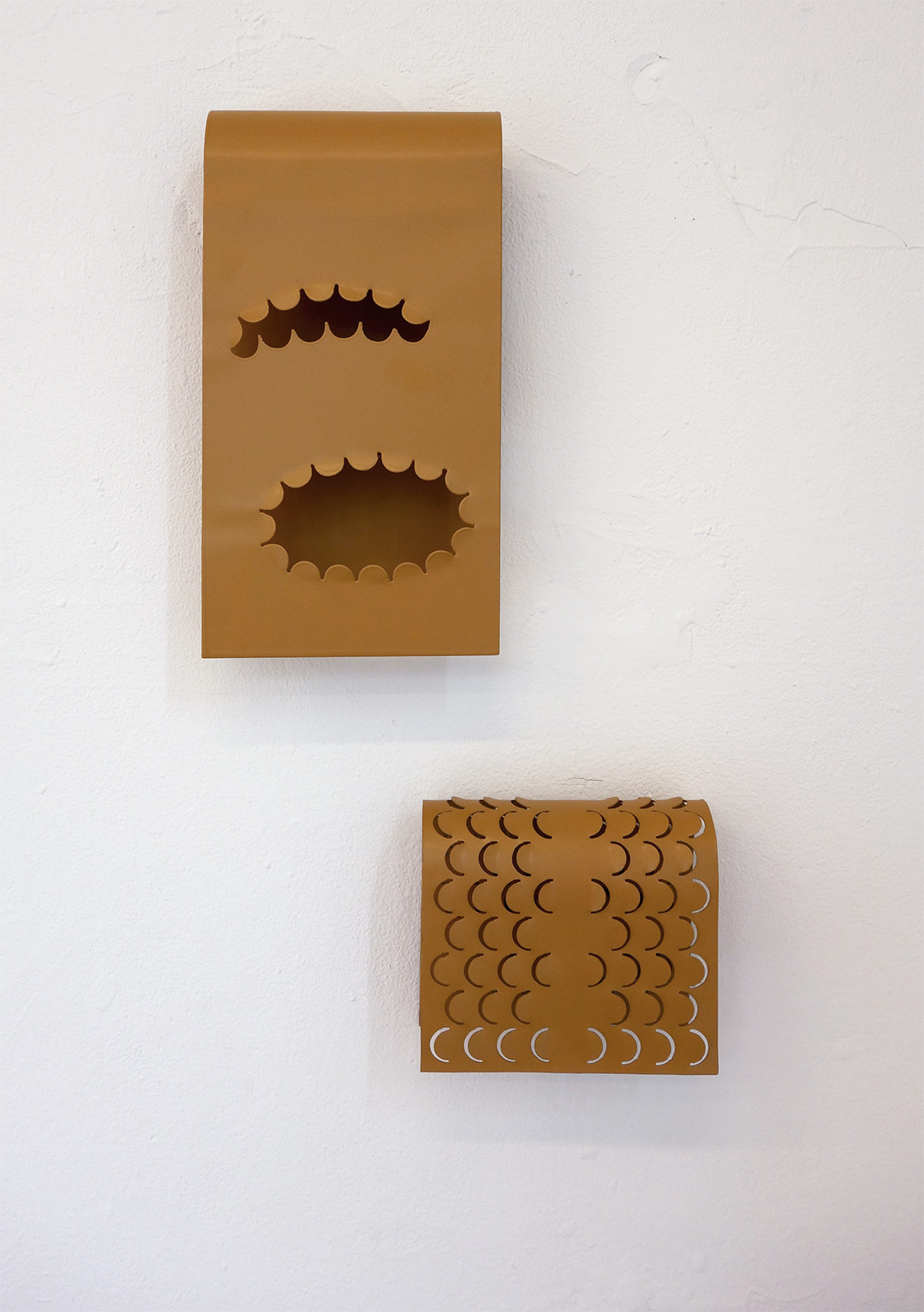 perforated, wall-mounted sculpture