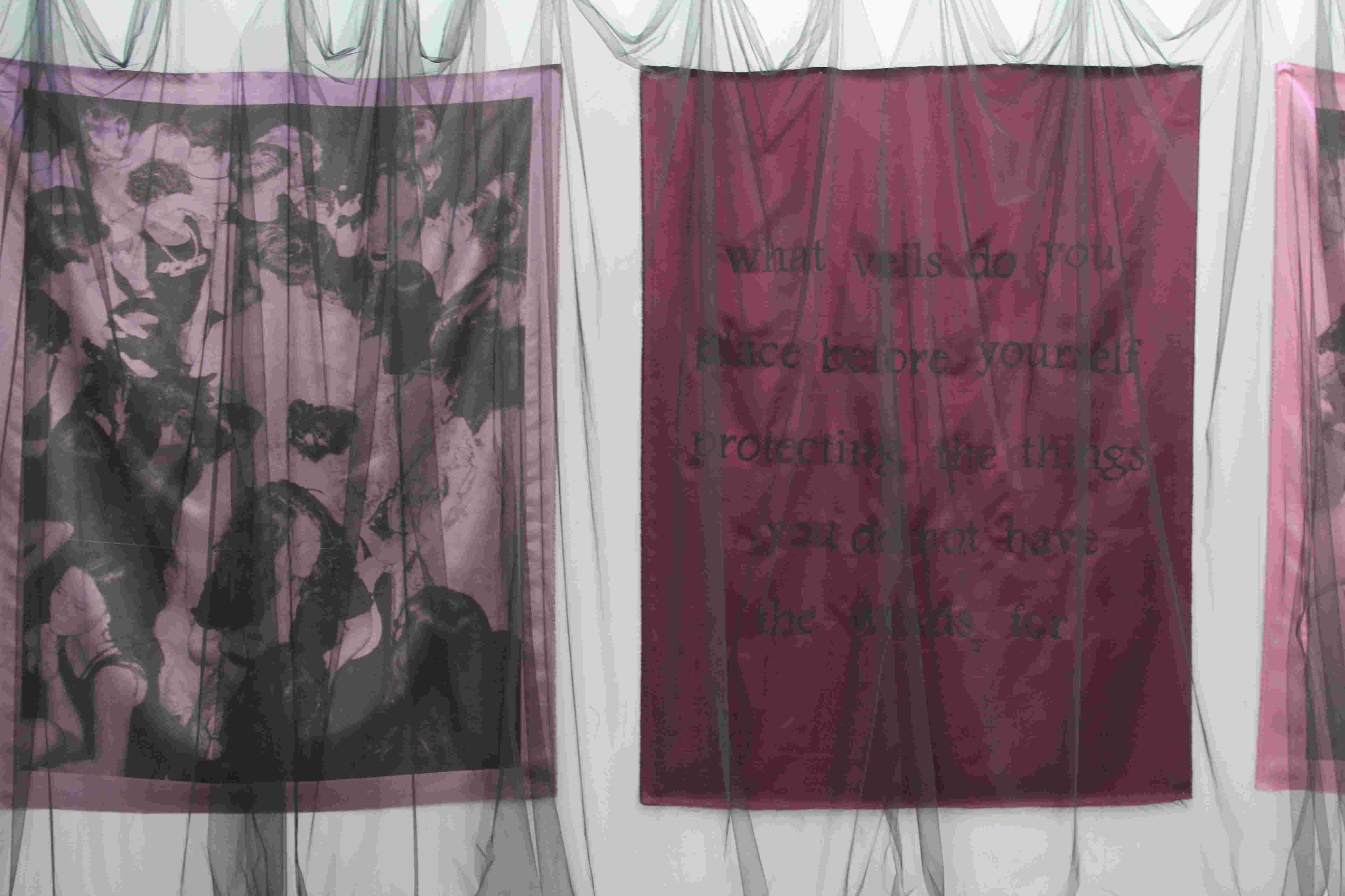 fabric with hand painted text reading 'what are the veils you place before yourself protecting the things you do not have the words for'