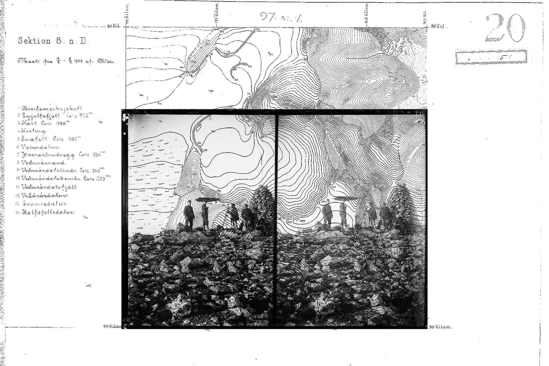 A black and white photo of people standing on rocky ground